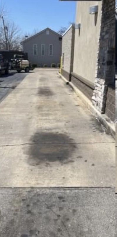 Dirty commercial driveway before pressure washing