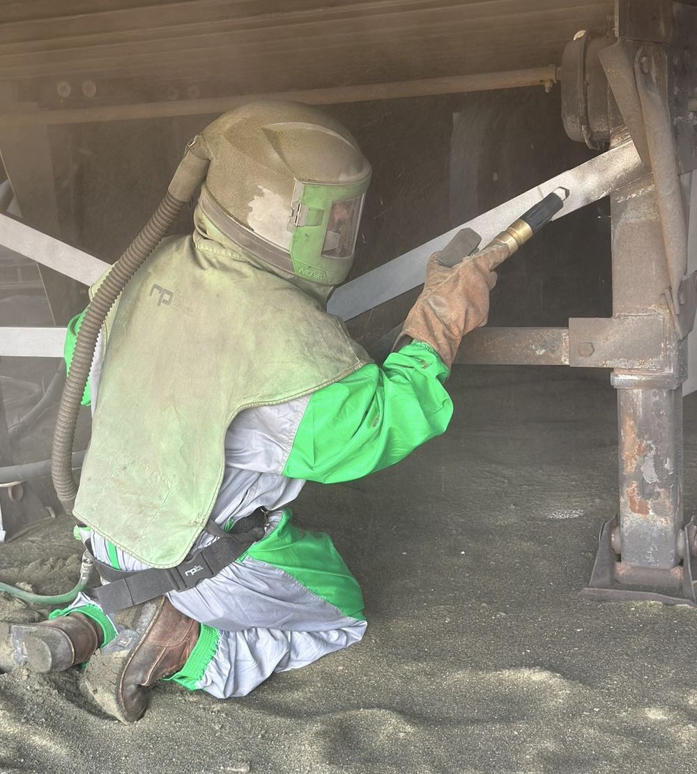 Sandblasting underneath a trailer