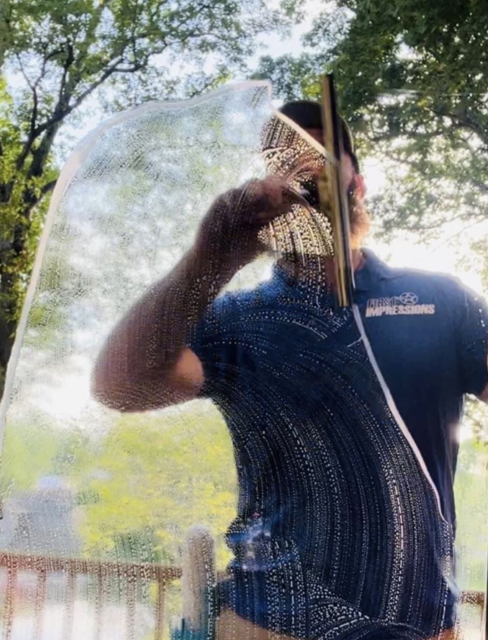 Cleaning a storefront window with a squeegee